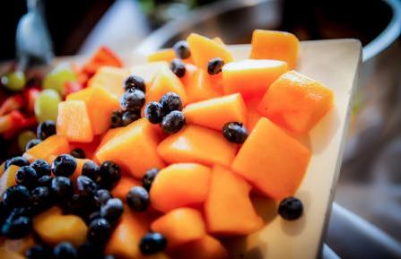 Cantaloupe cubes and blueberries on white platter.
